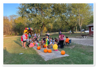 Kids having fun carving pumpkins at Wooded Acres RV Park